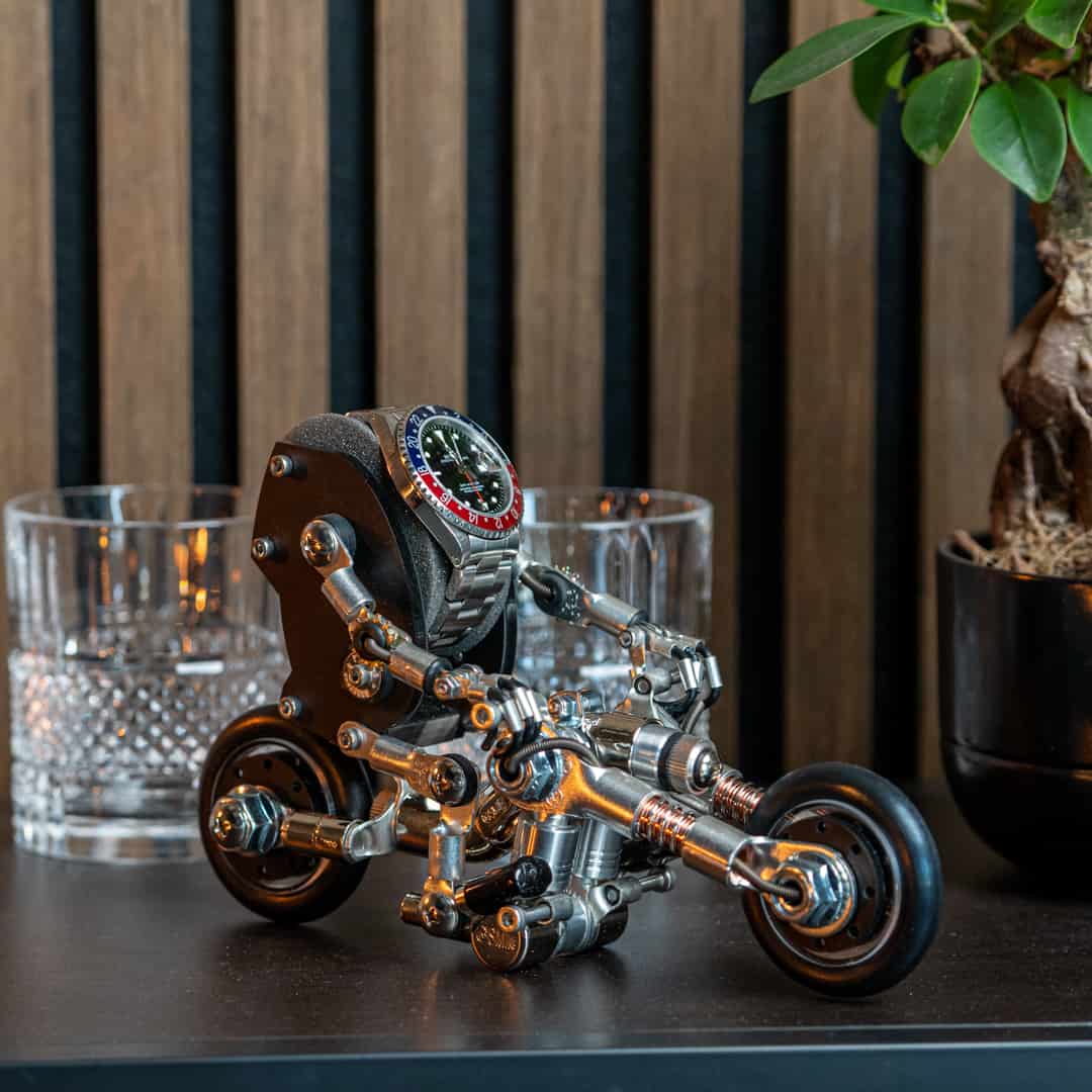 bike watch stand, watch holder, handmade, robotoys, watch display on counter, aesthetic photo  