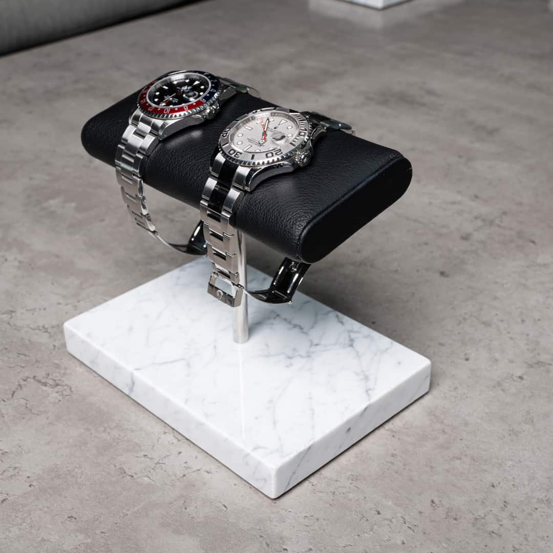 the watch stand duo, white marble, silver details, black cusion, italian calfskin leather, white carrara marble base plate, watch display, how to display your watches, display for two watches, watch stand scene